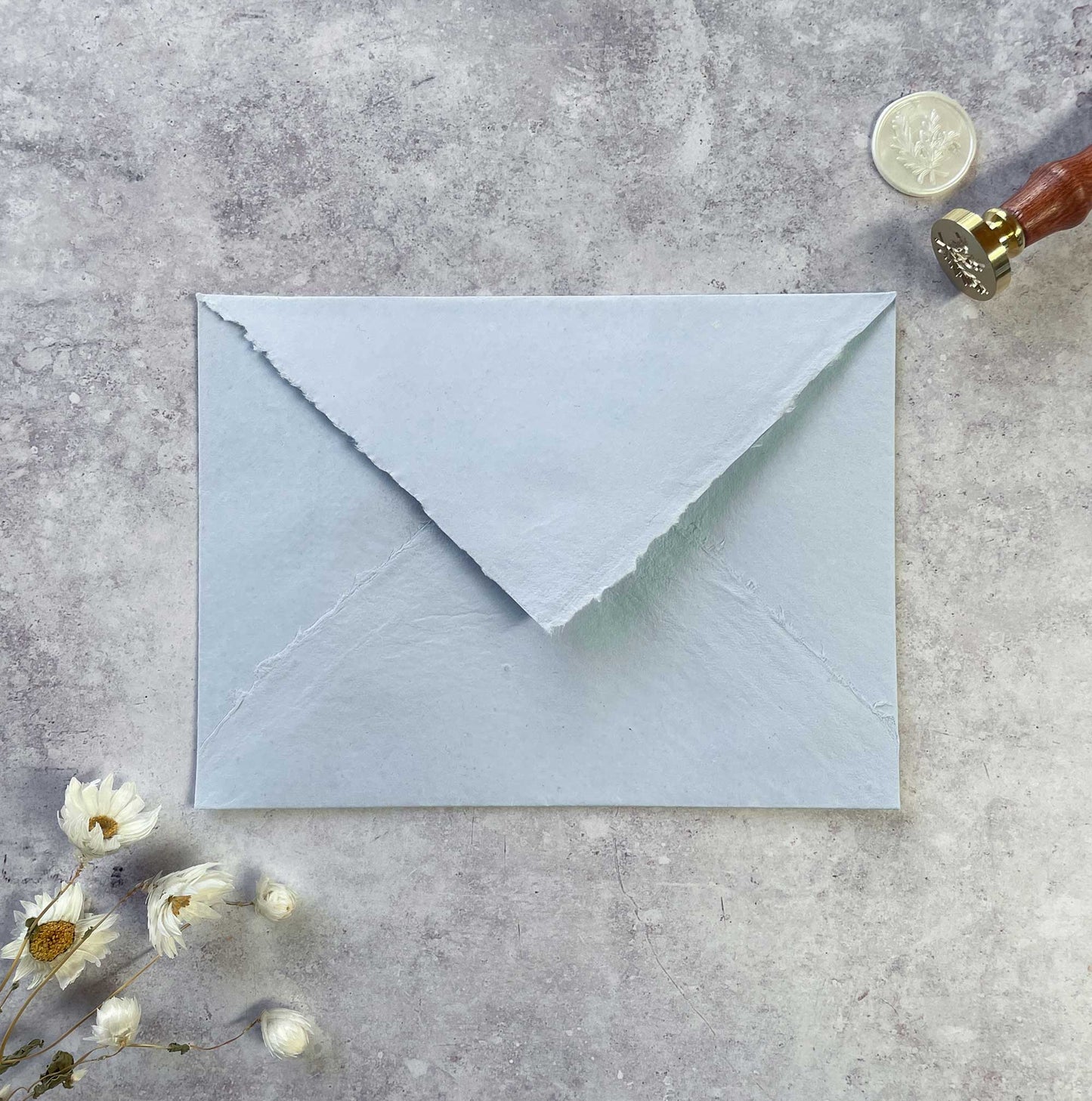handmade paper envelope with a deckled edge. Light blue invitation envelopes made from recycled cotton rag fibres. by The Natural Paper Company