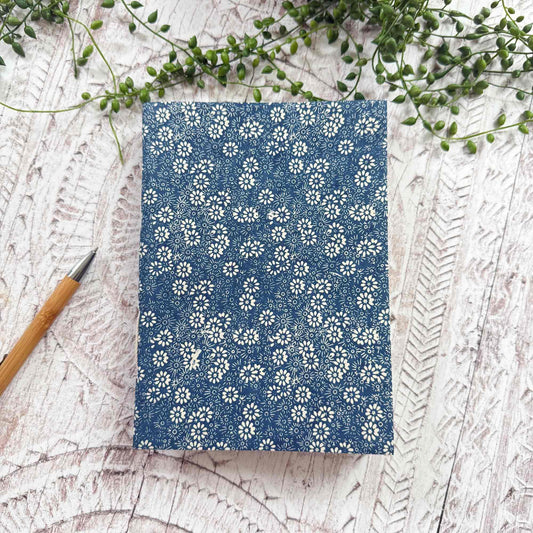 A5 Bellis Blue Lokta paper notebook by The Natural Paper Company. Handcrafted in Nepal from sustainable Lokta paper, with navy floral print and traditional hand‑stitched binding