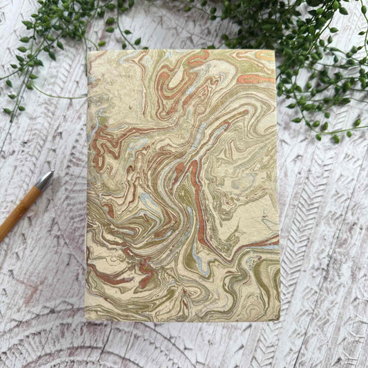A5 Midas Marble Lokta paper notebook by The Natural Paper Company. Hand‑marbled cover in gold, copper and silver tones, handmade in Nepal from sustainable Lokta paper