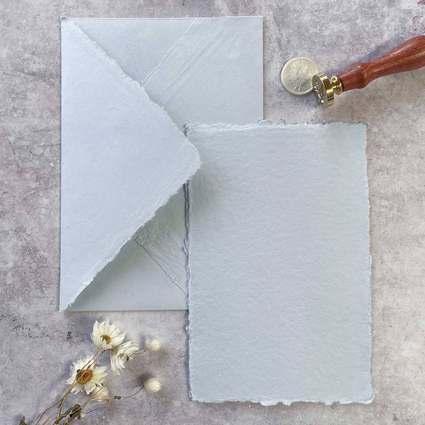 Light blue handmade cotton rag paper and envelope with a deckled edge. Recycled handmade paper for wedding stationery and crafts. by The Natural Paper Company