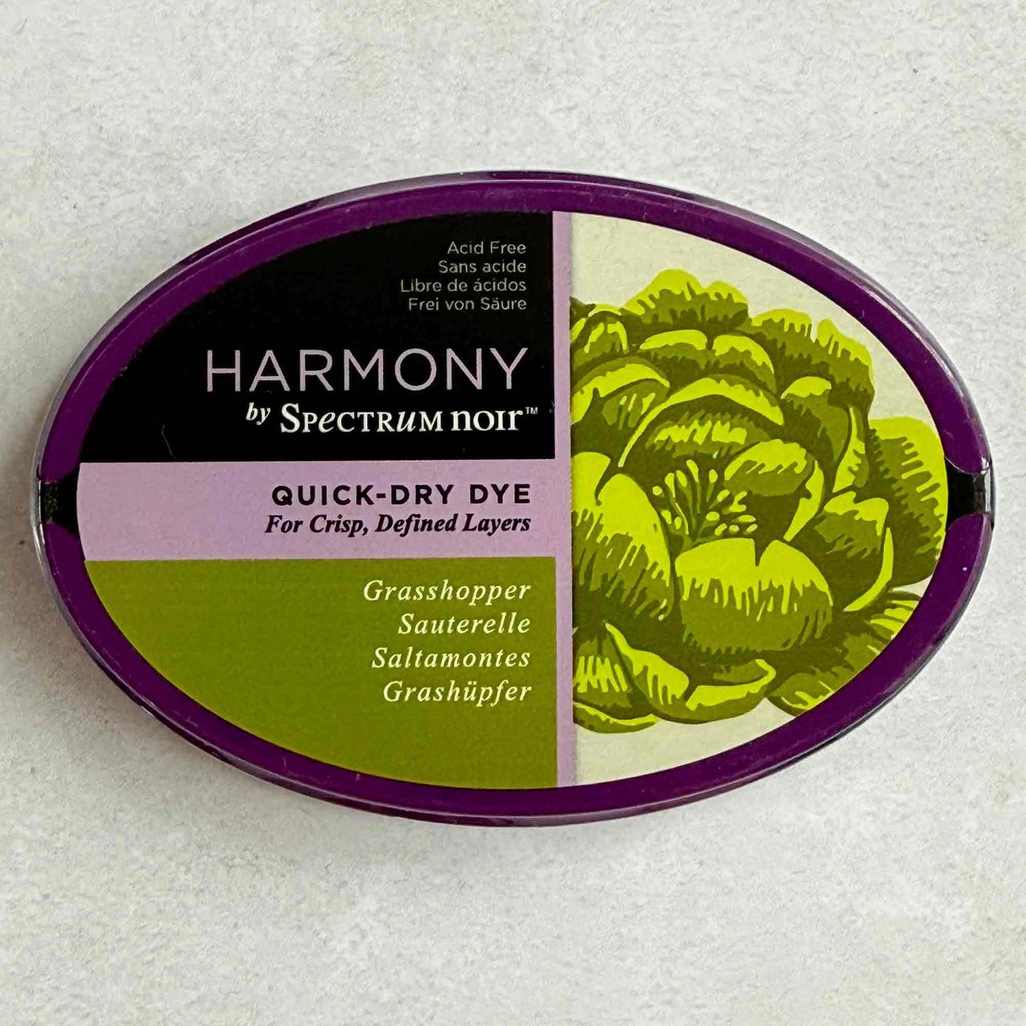Harmony by Spectrum Noir quick-dry dye container with grasshopper color on a textured white background