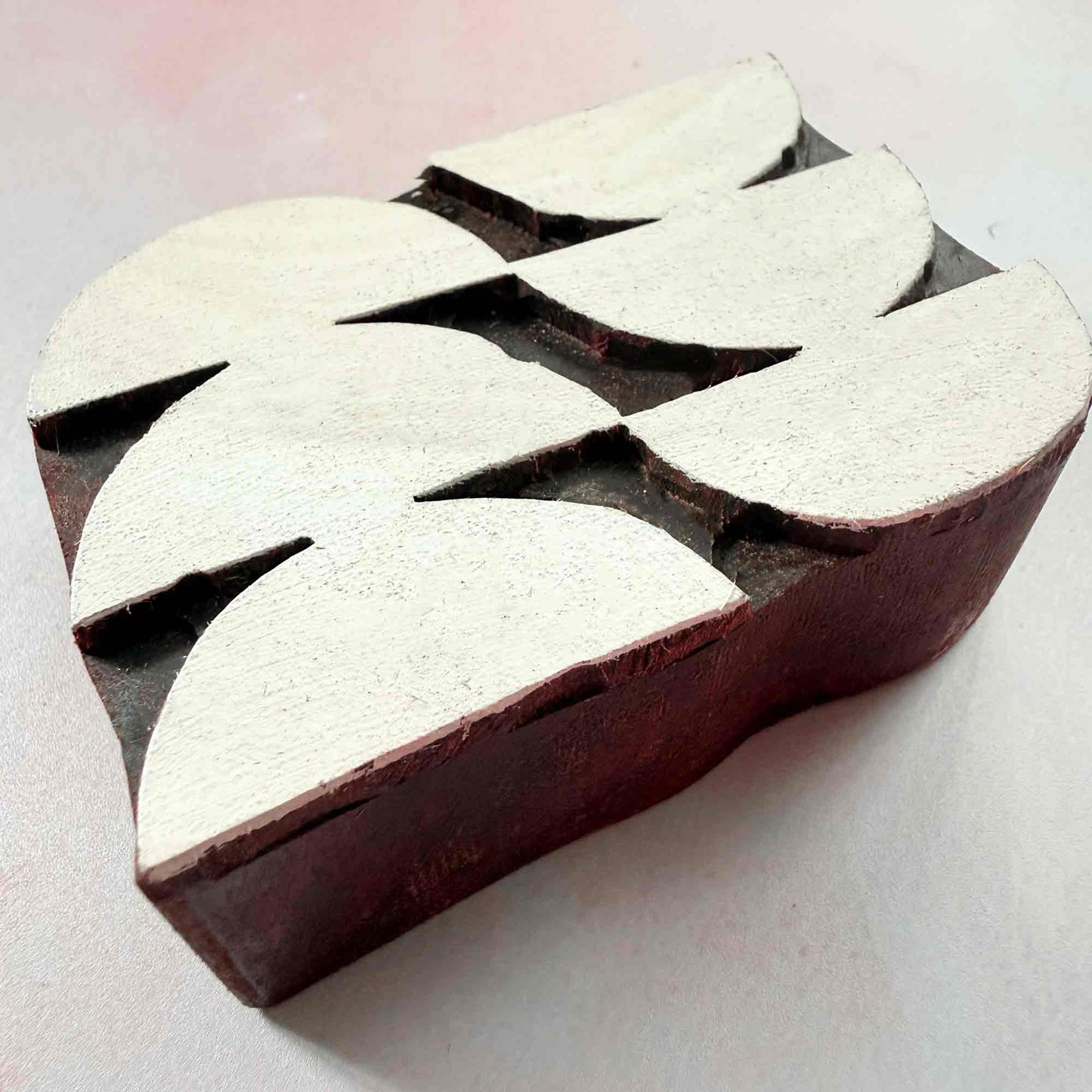 Harmony Indian wood block stamp — curved geometric design viewed from side