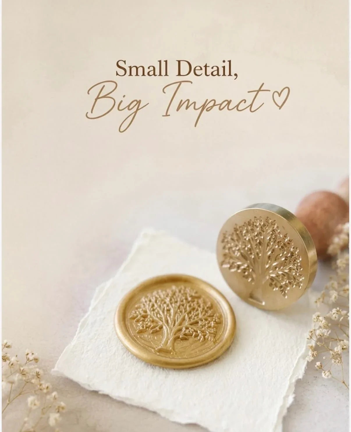 Close-up photograph of a metallic gold wax seal featuring a detailed Tree of Life impression, pressed onto deckle-edged handmade paper. Next to it is the brass stamp head engraved with the same tree design, attached to a smooth wooden handle. Text overlay: “Small Detail, Big Impact”. Warm soft tones with delicate dried flowers, from The Natural Paper Company.
