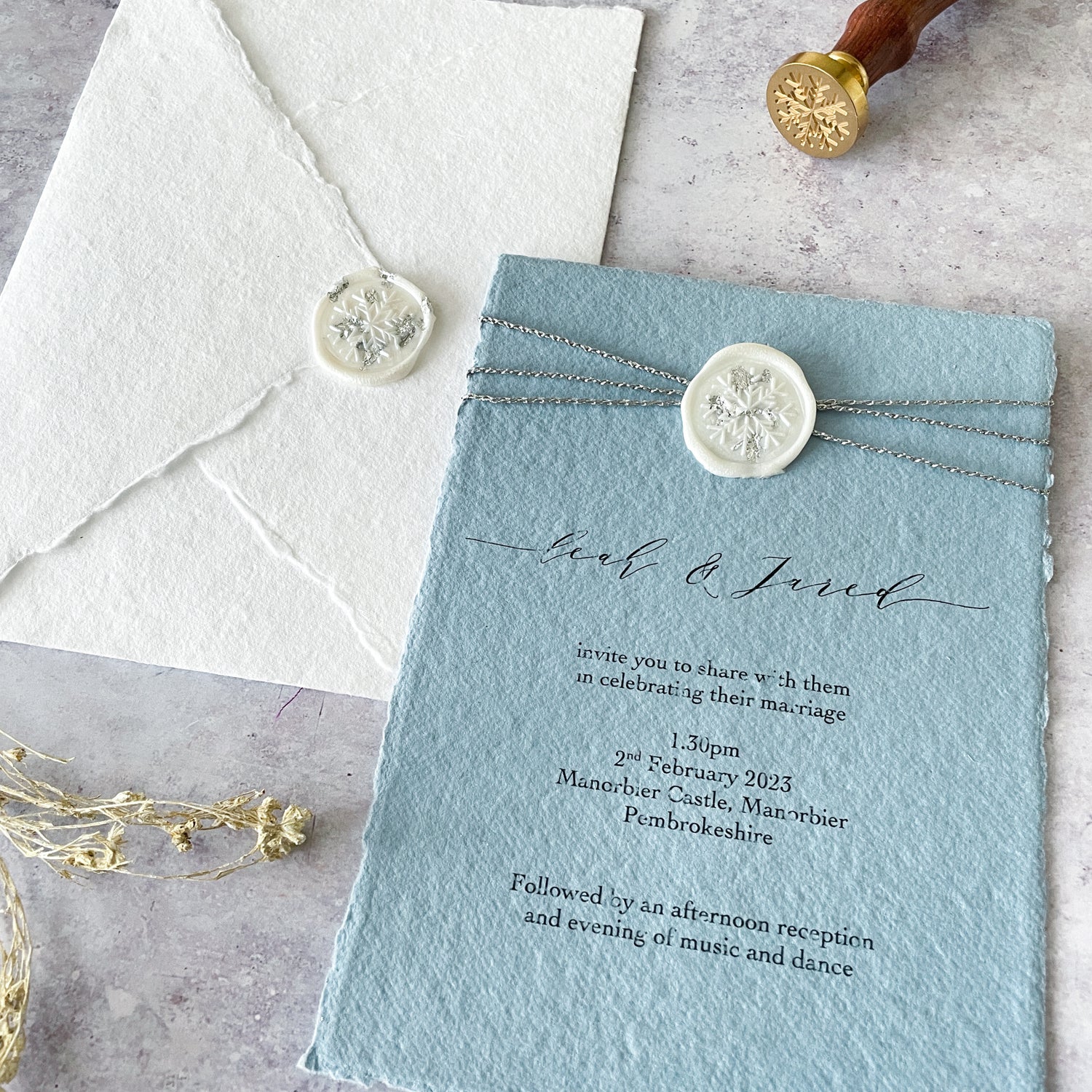Hand made paper and envelopes with wax stamp.  Winter wedding invitation made with handmade paper and wax stamp.  Blue and white .  The Natural Paper Company