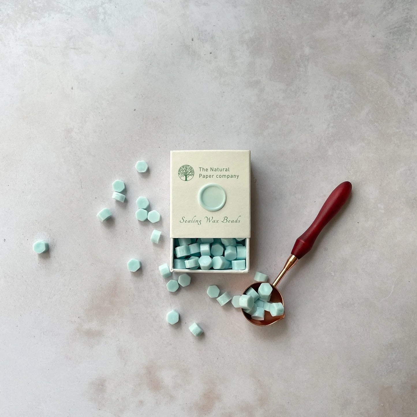 Aquamarine sealing wax beads in a box. Eco friendly wax beads for making wax seals in Aqua. By The Natural paper Company