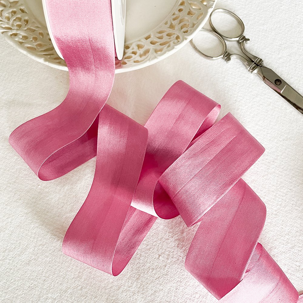 Luxury silk ribbon in raspberry pink colour. Fine habotai silk ribbon sold by the meter. By The Natural Paper Company