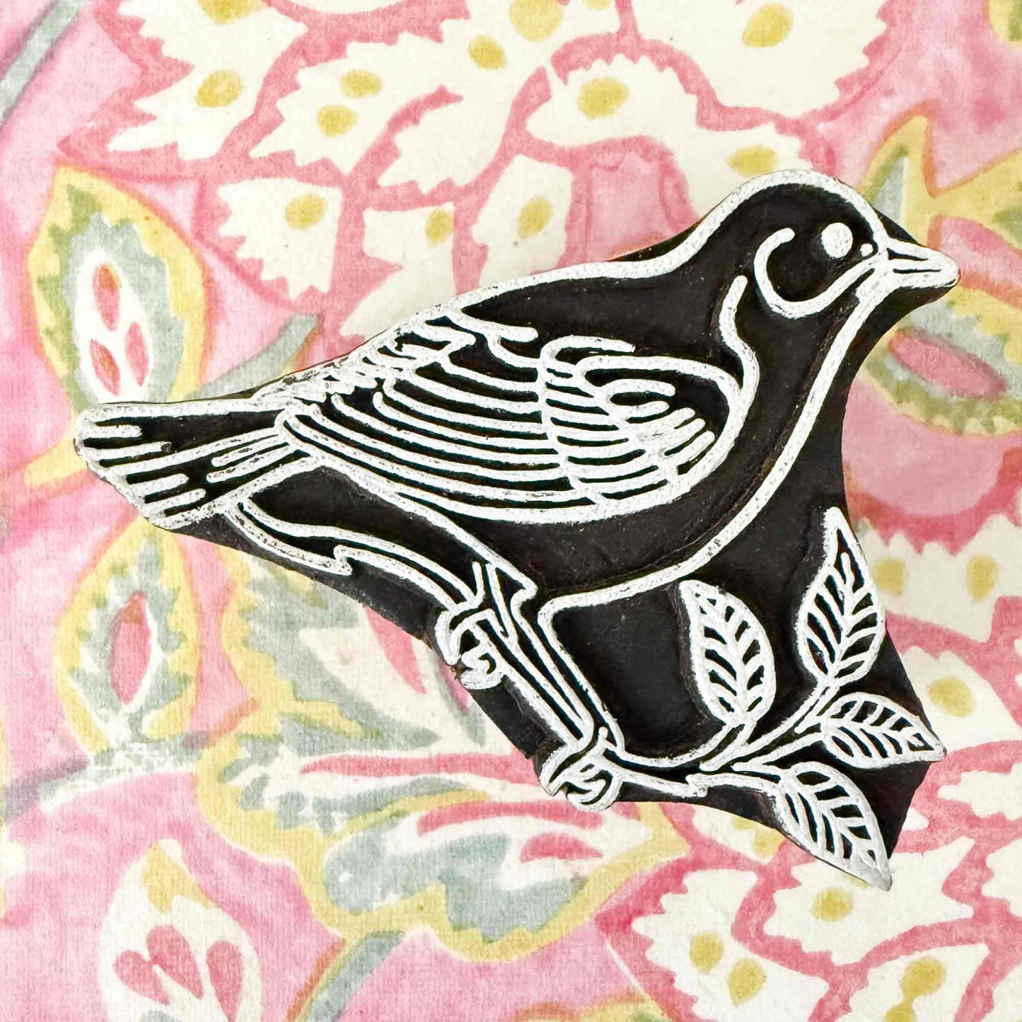 Wooden stamp with a bird and tree design