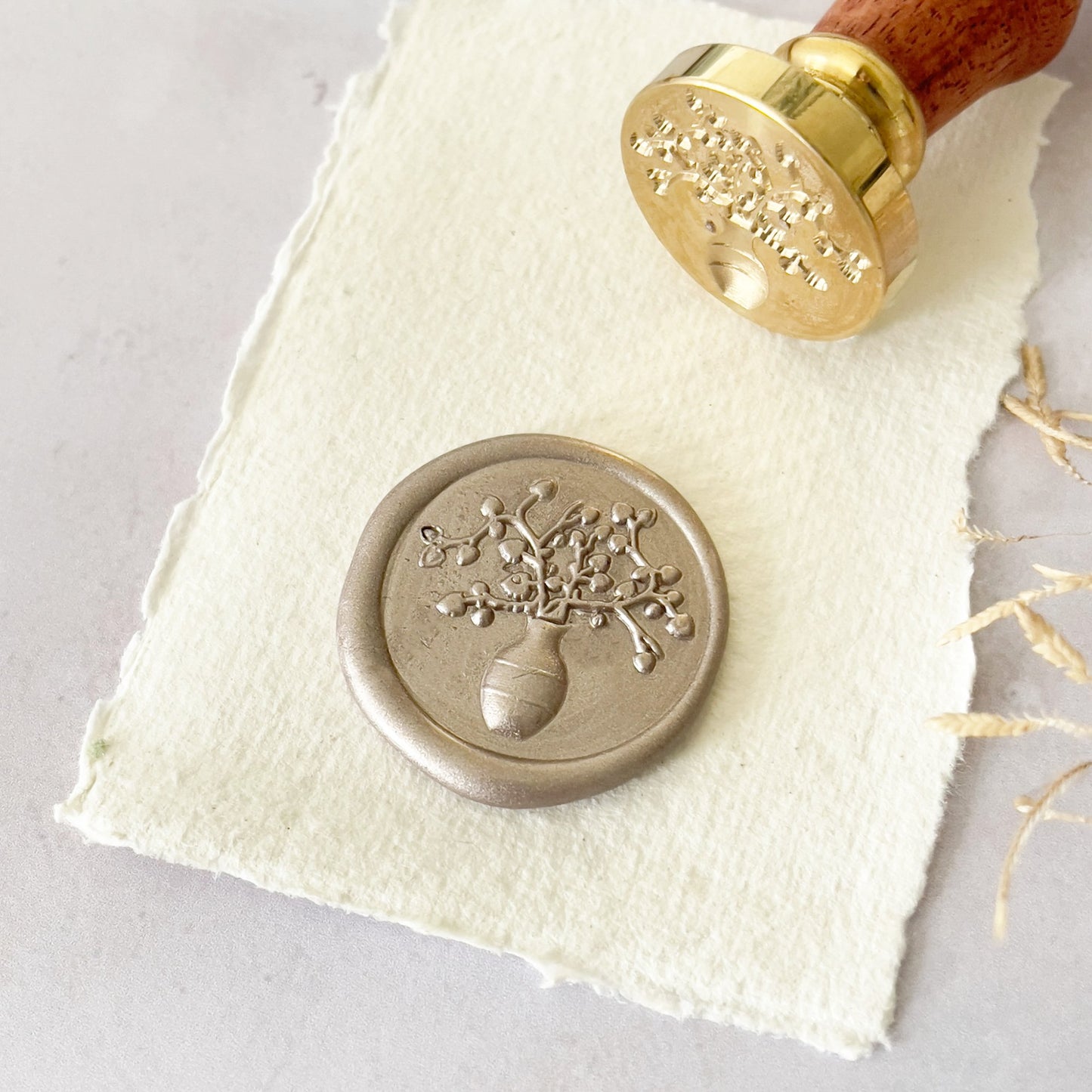 Grecian vase design wax seal stamp with a brass head and wooden handle. Make pretty wax seals to decoration invitations, envelope, stationery, gift wrapping and more. By The Natural Paper Company
