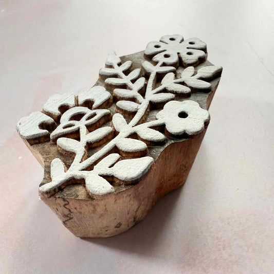 Wooden stamp with floral design on a light background