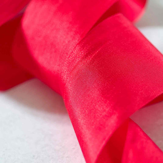 Close-up of 32.5mm Berry Red Habotai Silk Ribbon showing its silky texture and neat closed edges.