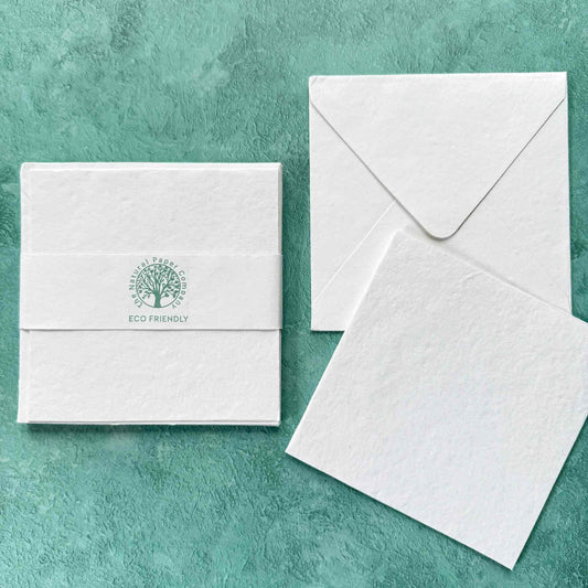 Eco-friendly stationery set with a card, envelope, and letterhead on a green textured background.