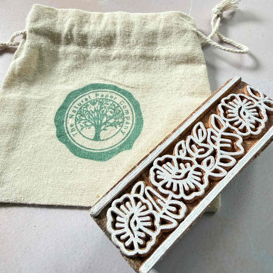 flowery border wooden stamp with branded gift bag from The Natural Paper Company