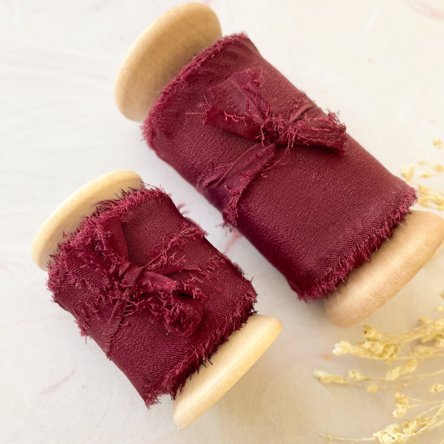 Silk ribbon for crafts. Burgundy silk ribbon on a wooden reel. Luxury silk ribbon with a raw edge. By The Natural Paper Company.