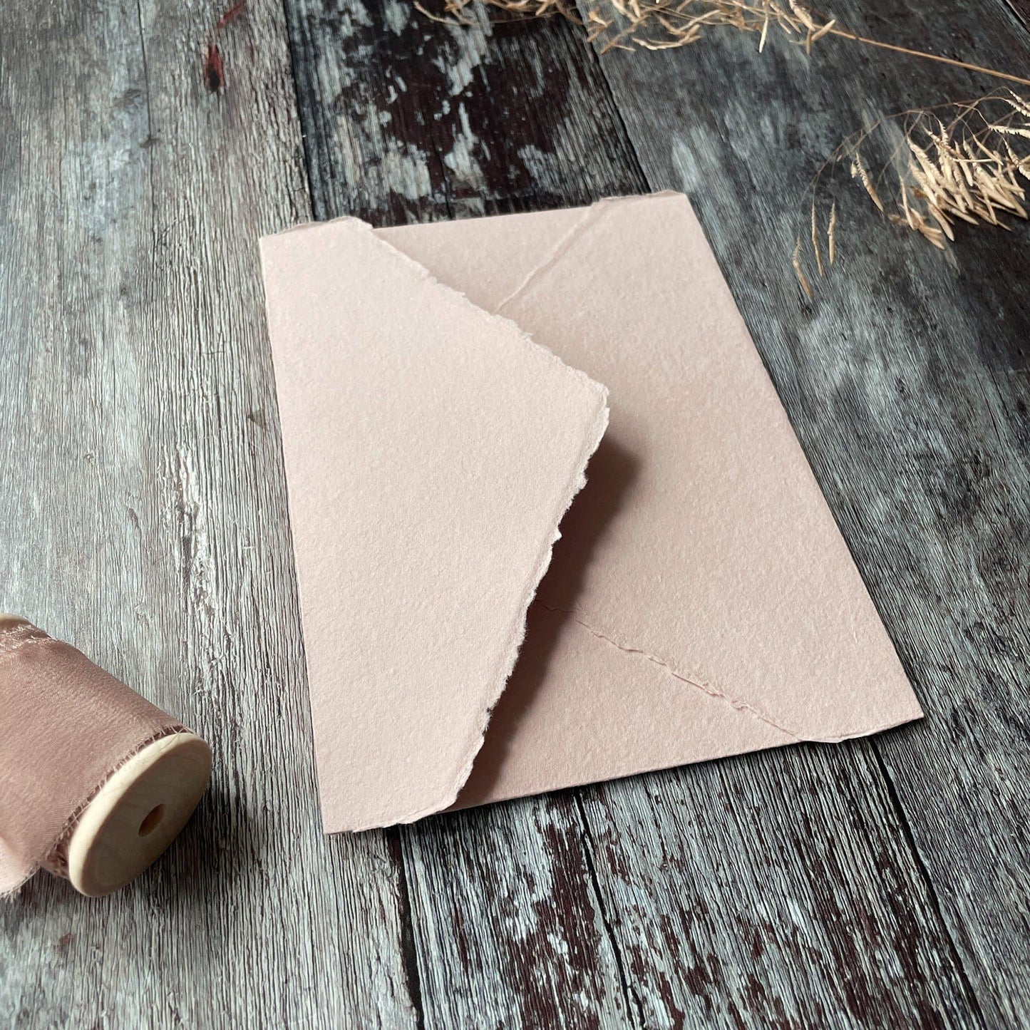 Handmade paper envelopes in blush pink. Made from Recycled cotton rag fibres, these deckled edge envelopes are perfect for invitations. By The Natural Paper Company
