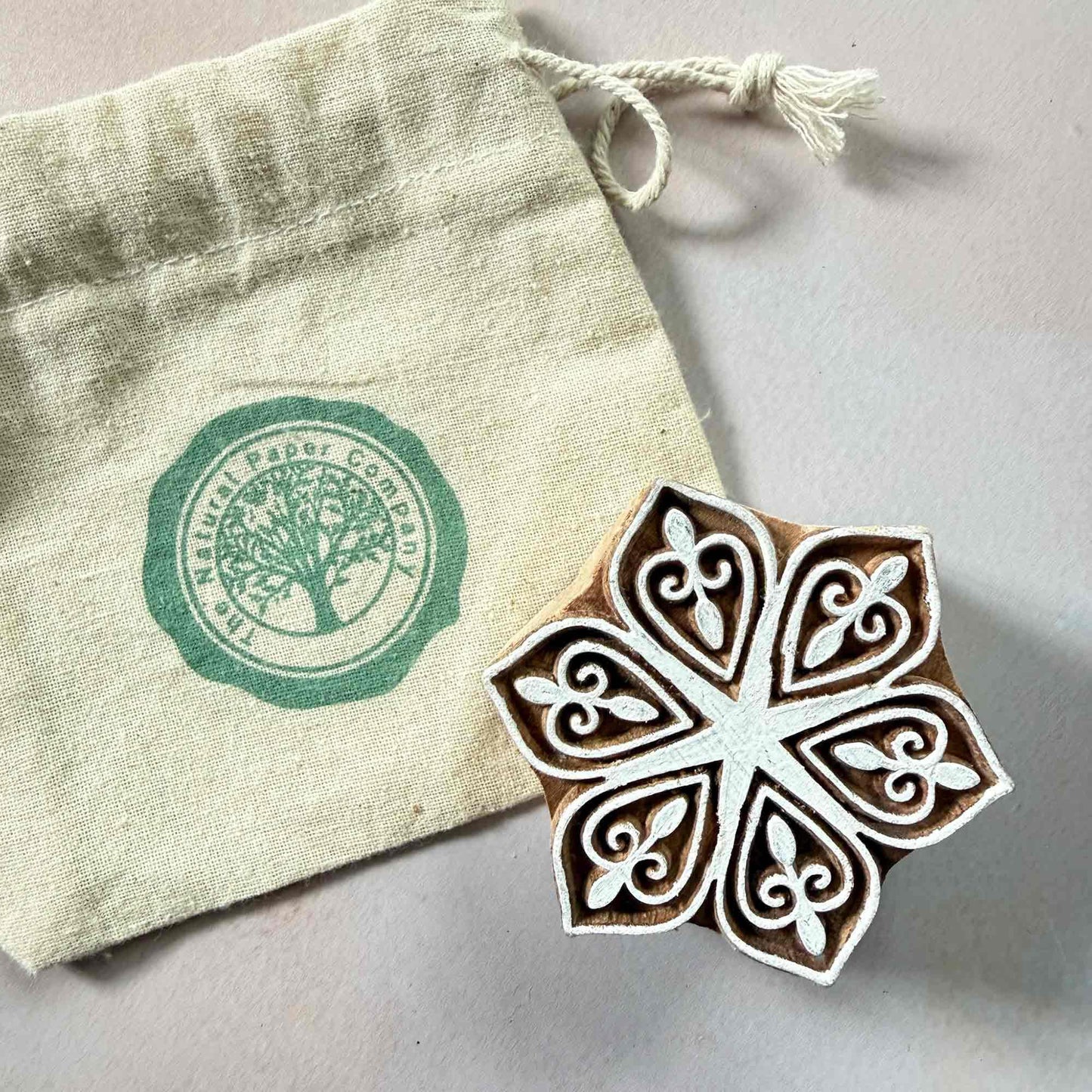 Decorative wooden stamp with intricate design and its own branded gift bag