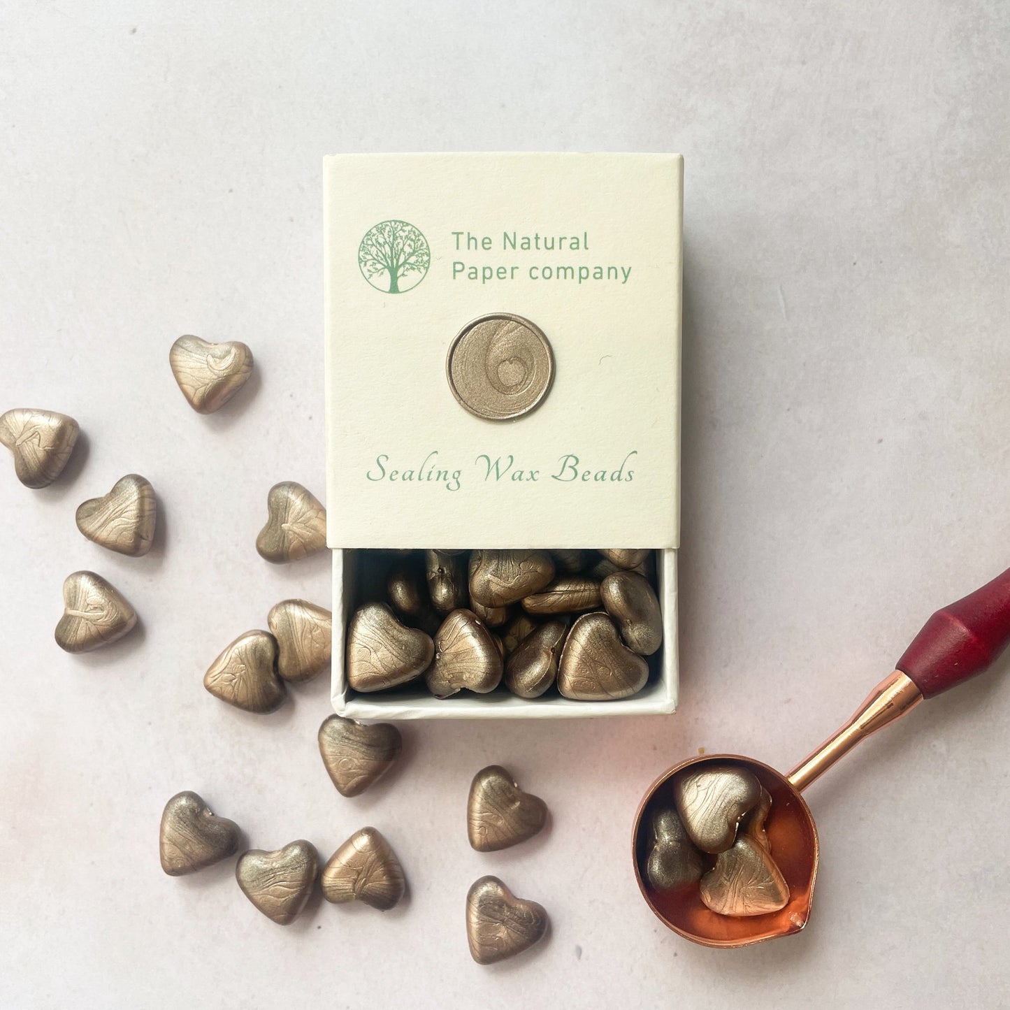 Box of sealing wax beads to make wax seals.  Champagne gold colour.  Eco friendly sealing wax for decorating wedding invitations, stationery, gift wrap, packaging, branding and more.  By The Natural paper Company