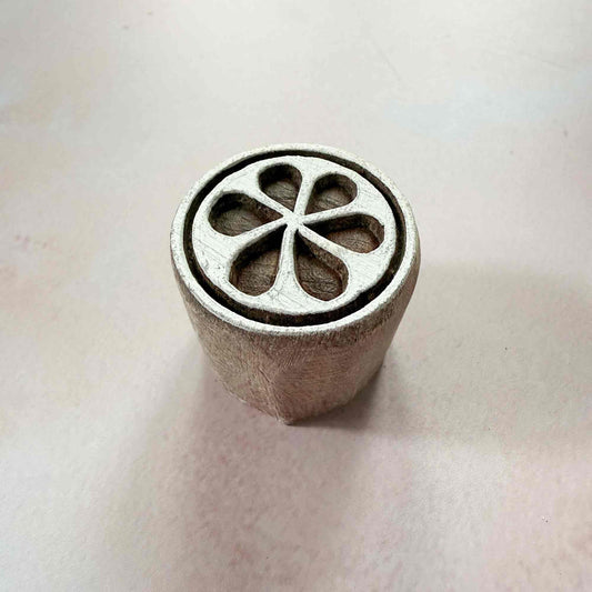 Metal stamp with a floral design on a light background