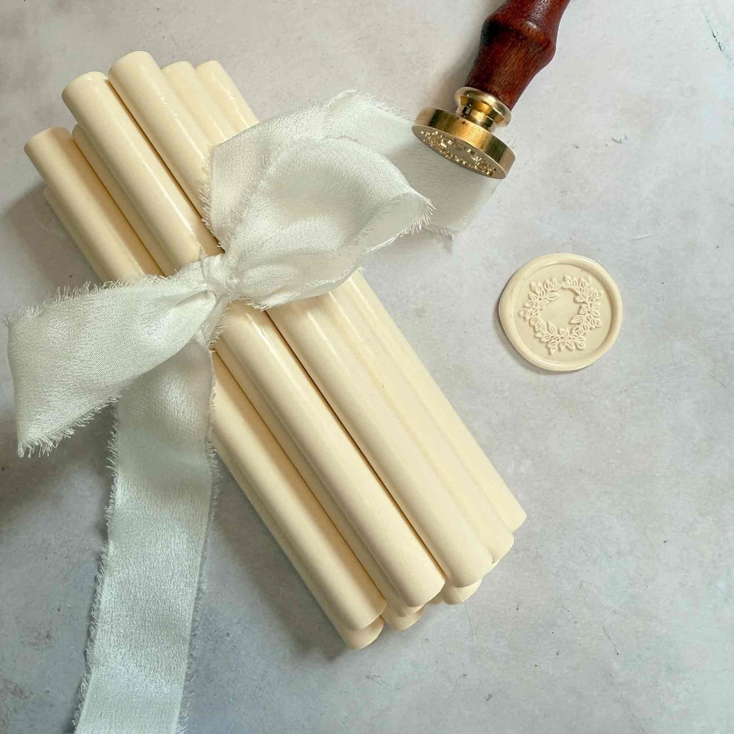 Set of wax seals with a ribbon and a stamp on a light background