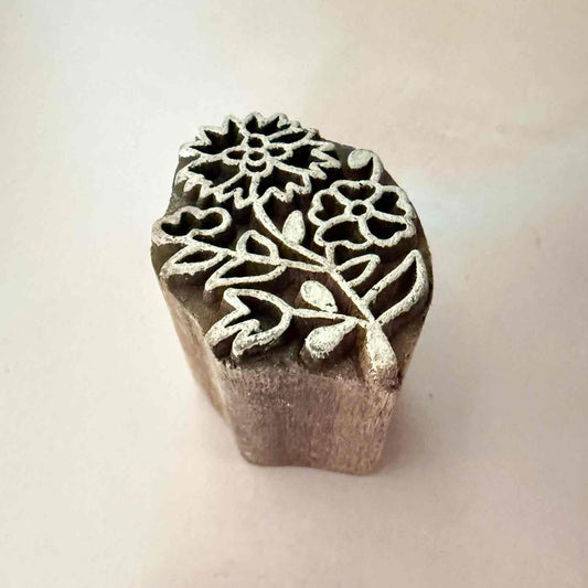 Wooden stamp with floral design on a light background