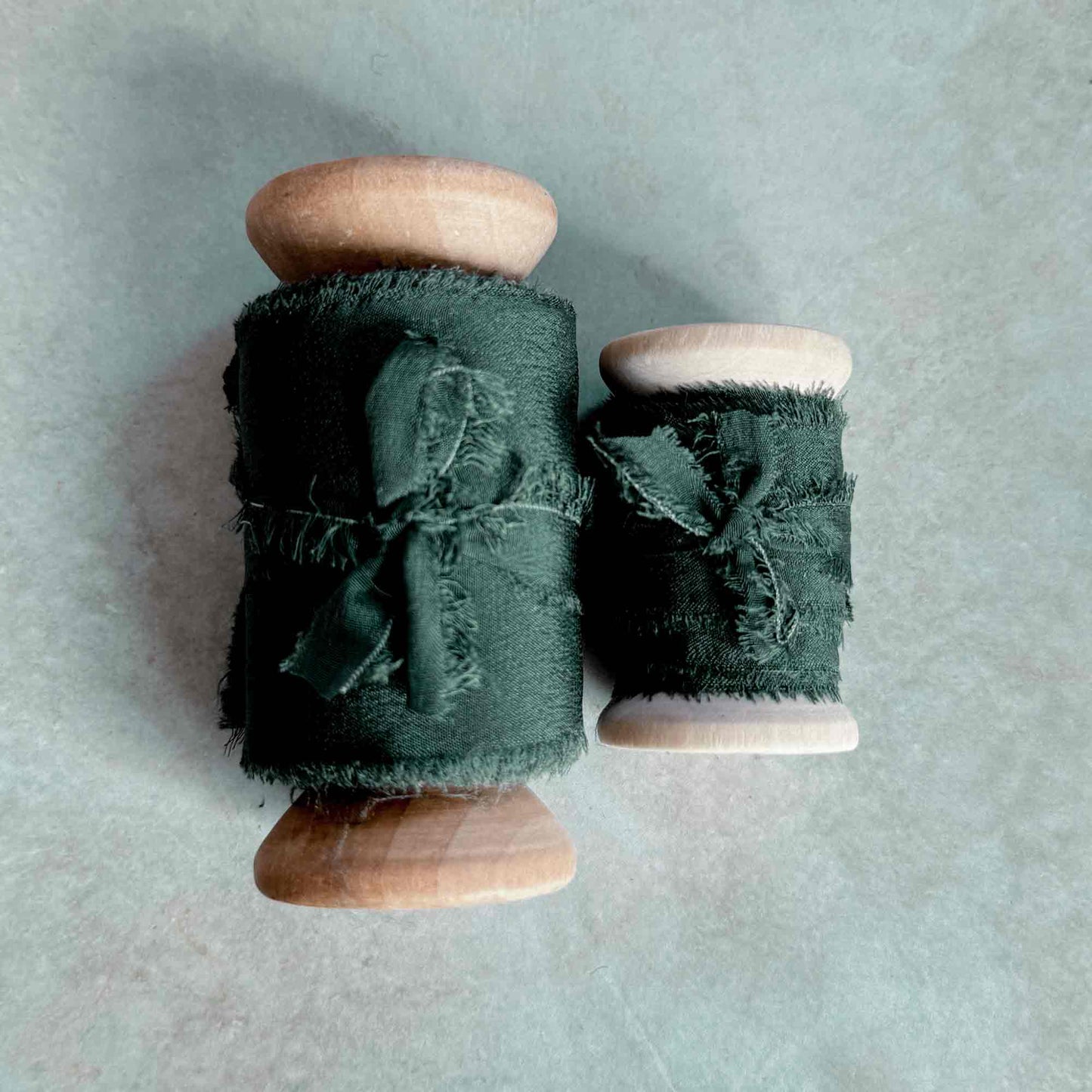 dark green ribbon with a frayed edge