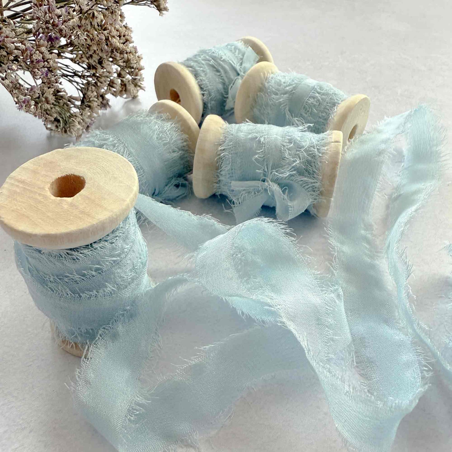 Light blue silk ribbon with a frayed edge