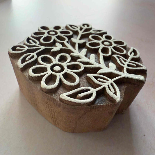 Wooden stamp with floral design on a light background