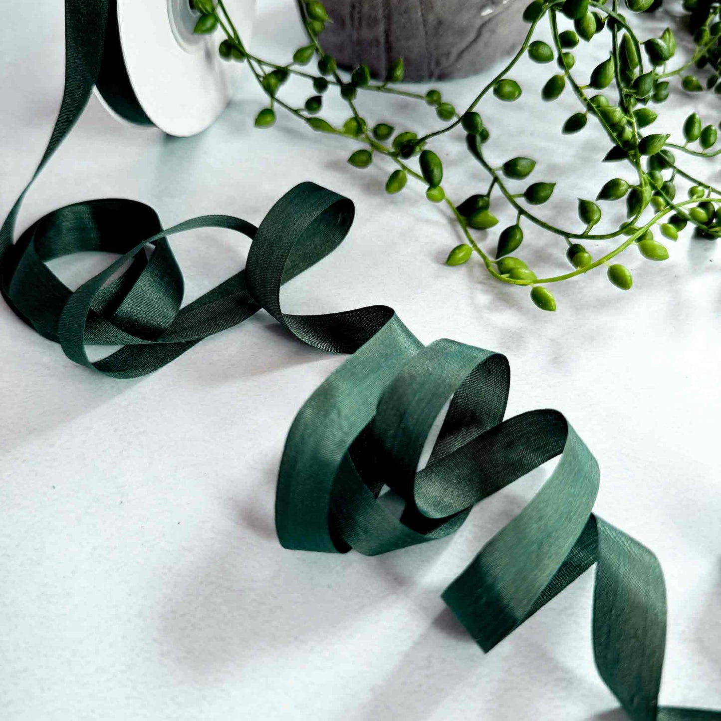 Forest green habotai silk ribbon in a narrow width