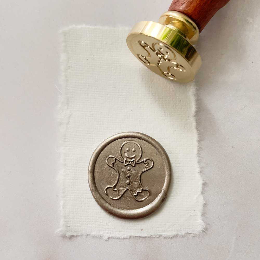 Gingerbread man wax stamp. Seasonal theme stamp for making wax seals. Brass head with a wooden handle.