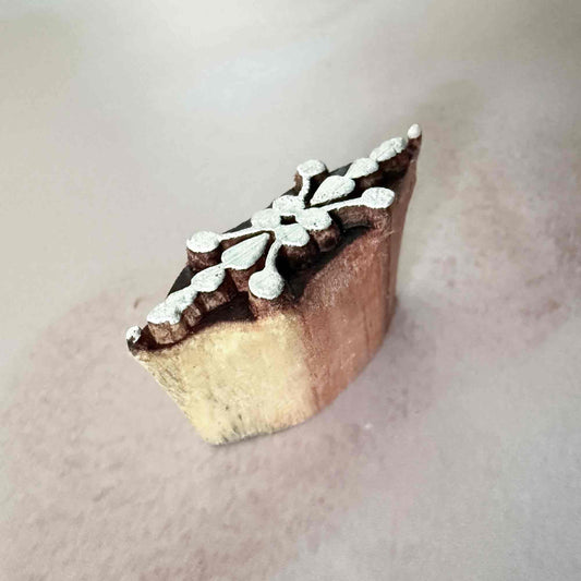 Wooden stamp with floral design on a light background