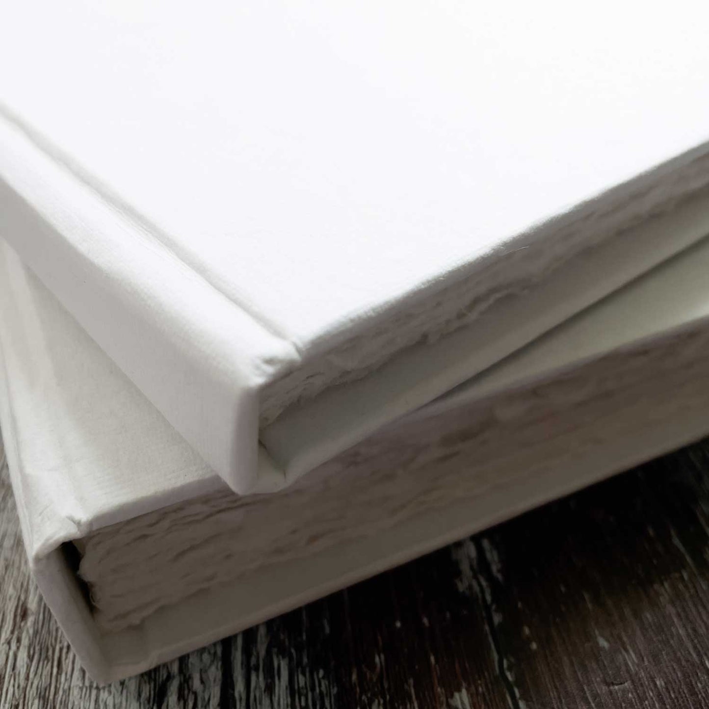 Blank hard cover books in White. Handmade from recycled cotton rag paper. Deckled edge pages. Perfect to use as as artist watercolour pad, wedding guest book, journal or personalised note book. 2 sizes available. By The Natural Paper Company