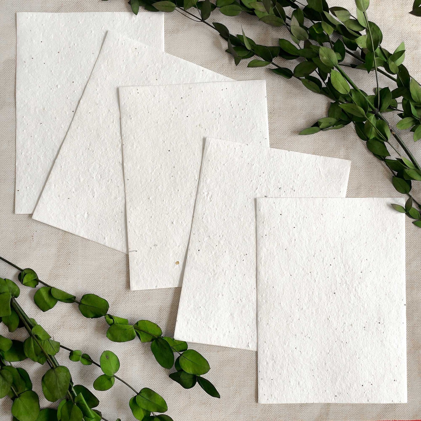 Handmade white paper with basil seeds. Plantable paper for invitations and stationery. By The Natural Paper Company