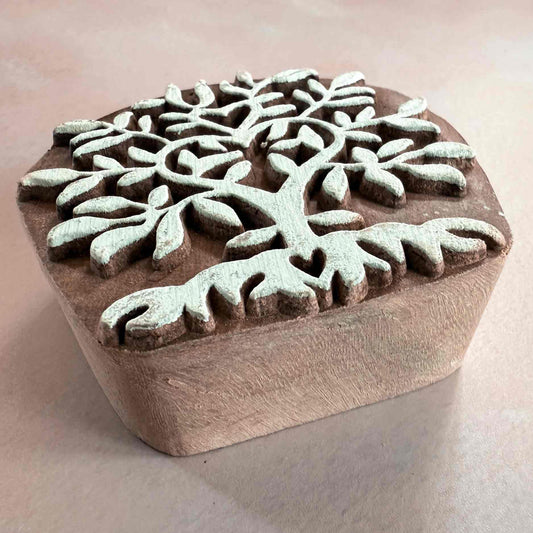 Wooden stamp with a snowflake design on a beige background