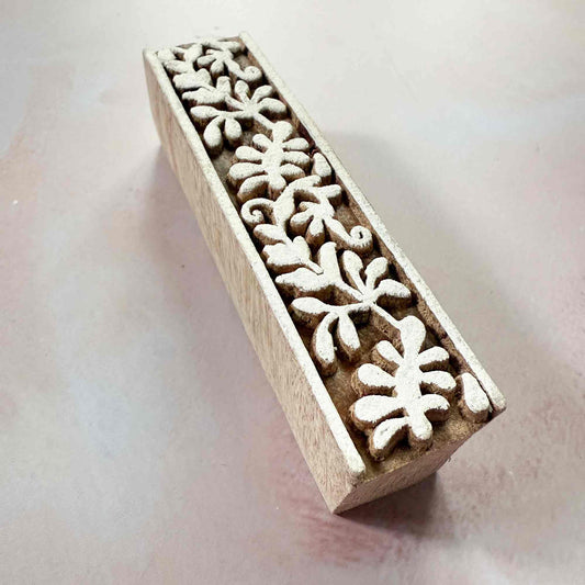 Wooden stamp with snowflake pattern on a light background