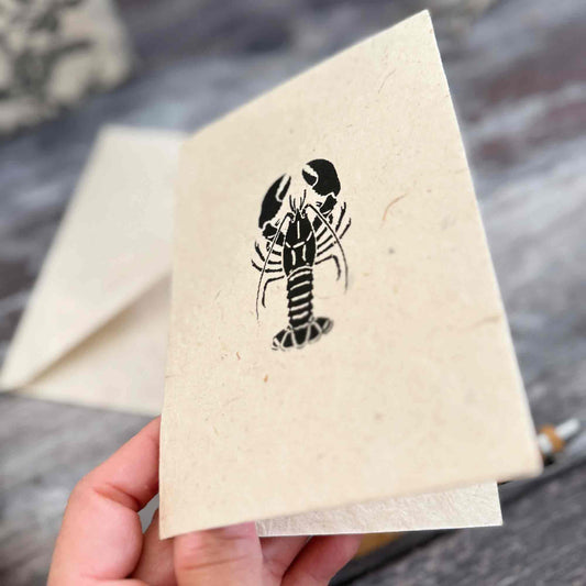 Handmade Lokta paper lobster card with matching natural envelope and black coastal design