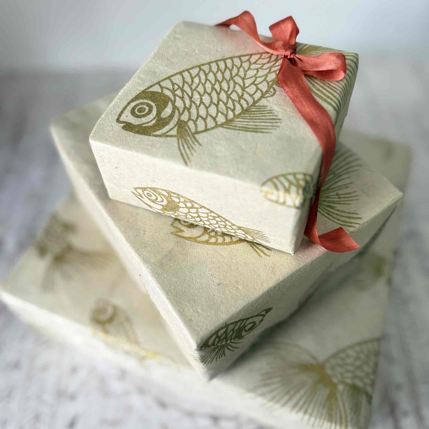 Handmade Lokta paper gift wrap – gold fish print on natural cream textured paper
