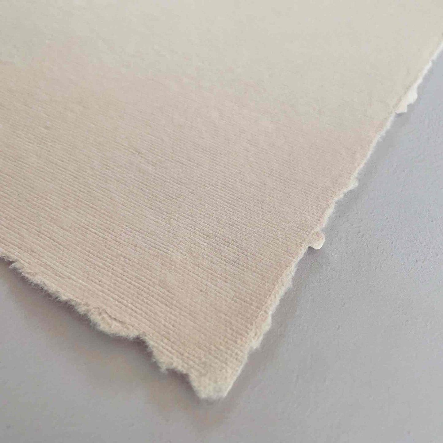 Handmade cotton rag paper with deckled edges, soft blush pink colour paper