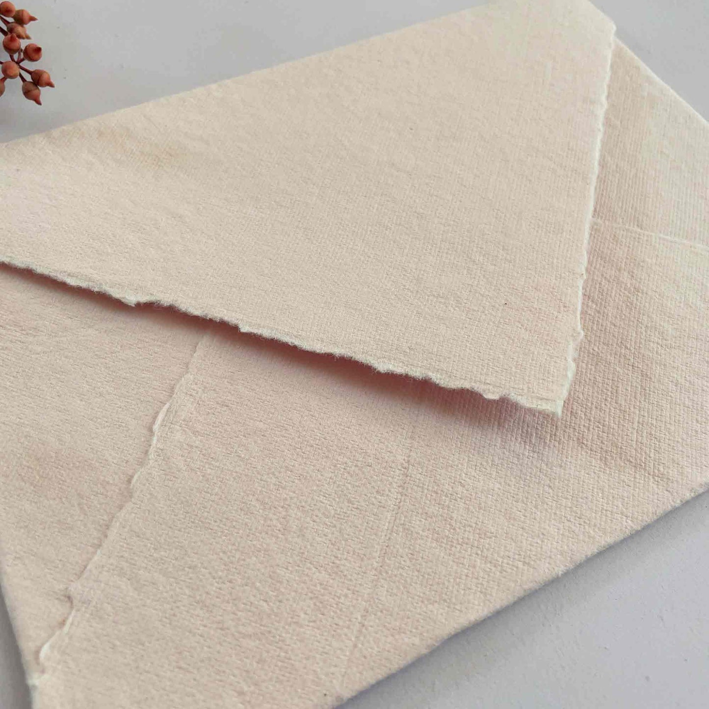 handmade paper envelope in blush pink. Made from recycled cotton rag fibres
