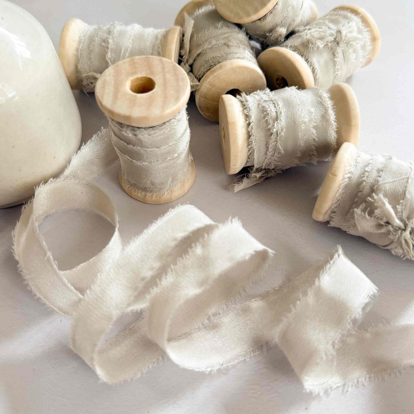 Neutral beige silk ribbon for decorating place cards and tags. Fine silk ribbon with a raw edge