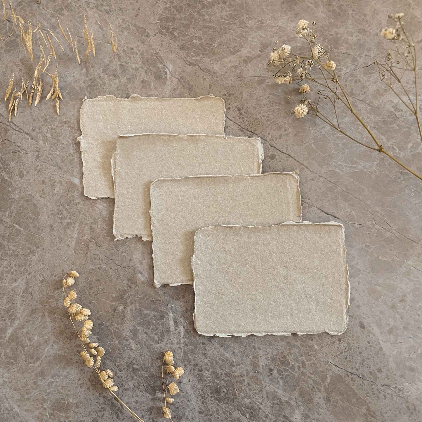 Small pieces of natural handmade cotton rag card with deckled edges.  By The Natural Paper Company