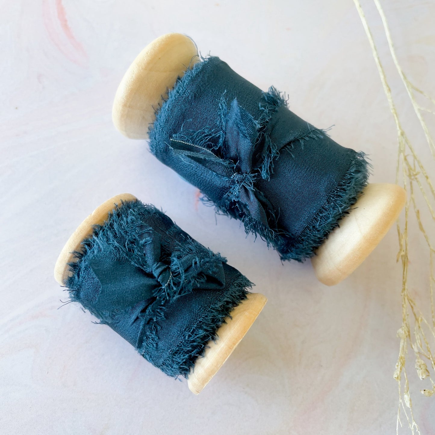 Luxury silk ribbon sold on a wooden reel. Fine habotai silk in navy. Perfect ribbon for decorating wedding invitations, stationery and for use in floristry. By The Natural Paper Company