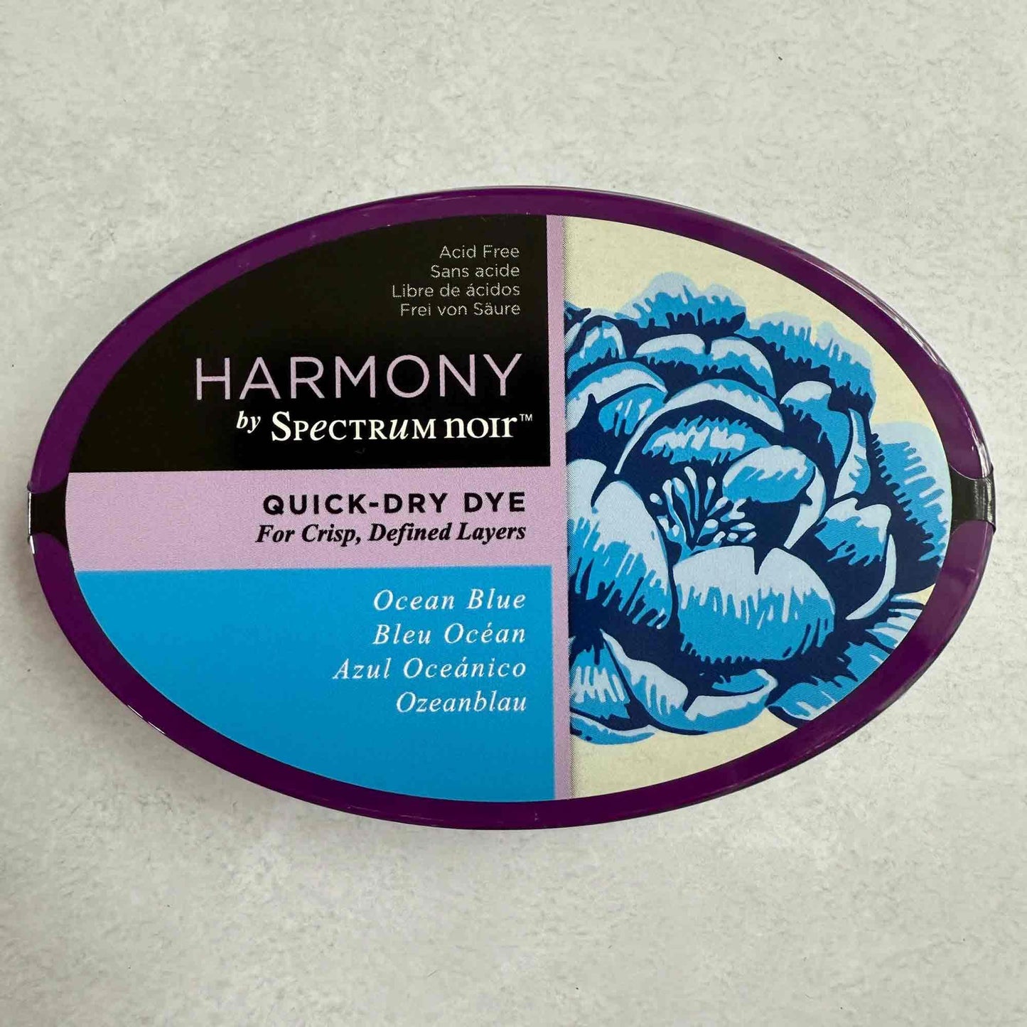 Harmony by Spectrum Noir quick-dry dye container with blue floral design on a gray background
