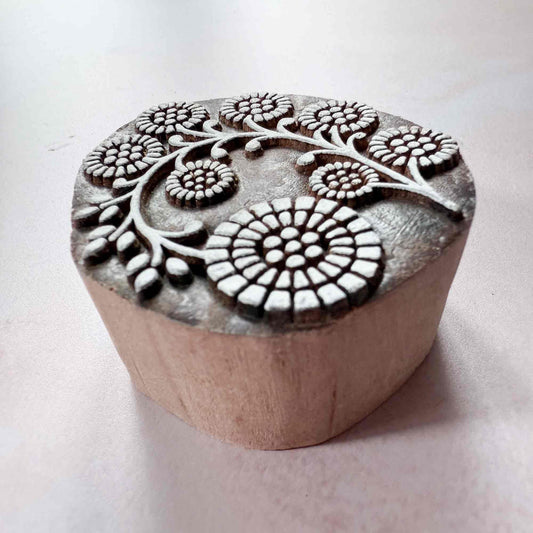 Wooden stamp with floral patterns on a white background