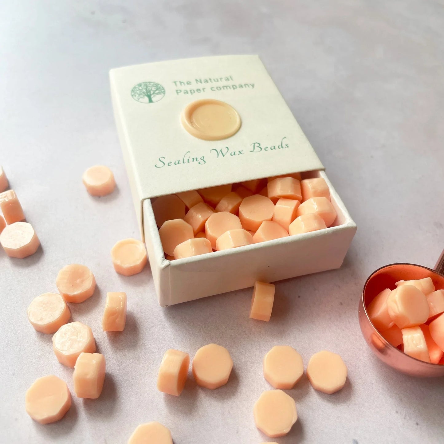 Peach sealing wax beads to make wax seals. Small box of eco friendly sealing wax in peach. Paraffin free, plastic free and biodegradable. Perfect for making wax seals for wedding invitations, stationery, gift wrapping or packaging. By The Natural paper Company