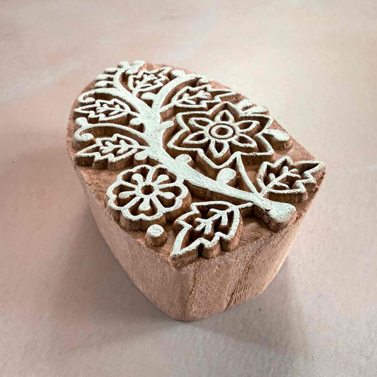 Wooden stamp with floral patterns on a light background