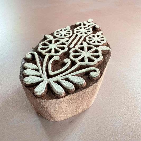 Wooden stamp with floral patterns on a beige background