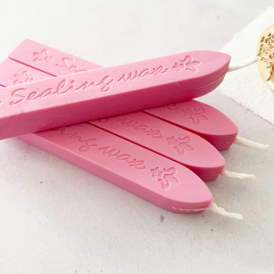 pink sealing wax sticks with wicks