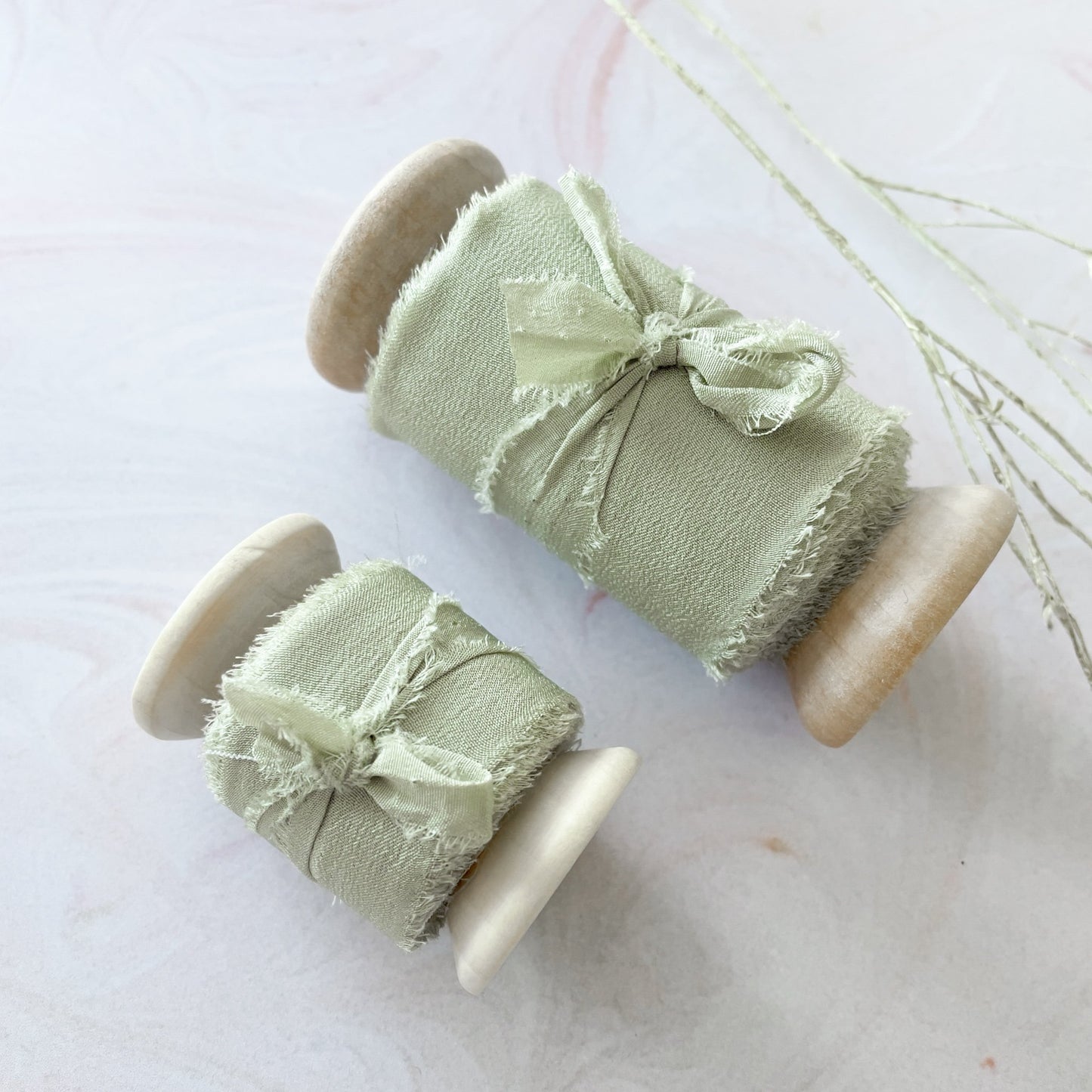 Sage green silk ribbon for crafts. Luxury silk ribbon on a wooden reel. Perfect for floristry and wedding stationery. By The Natural Paper Company.