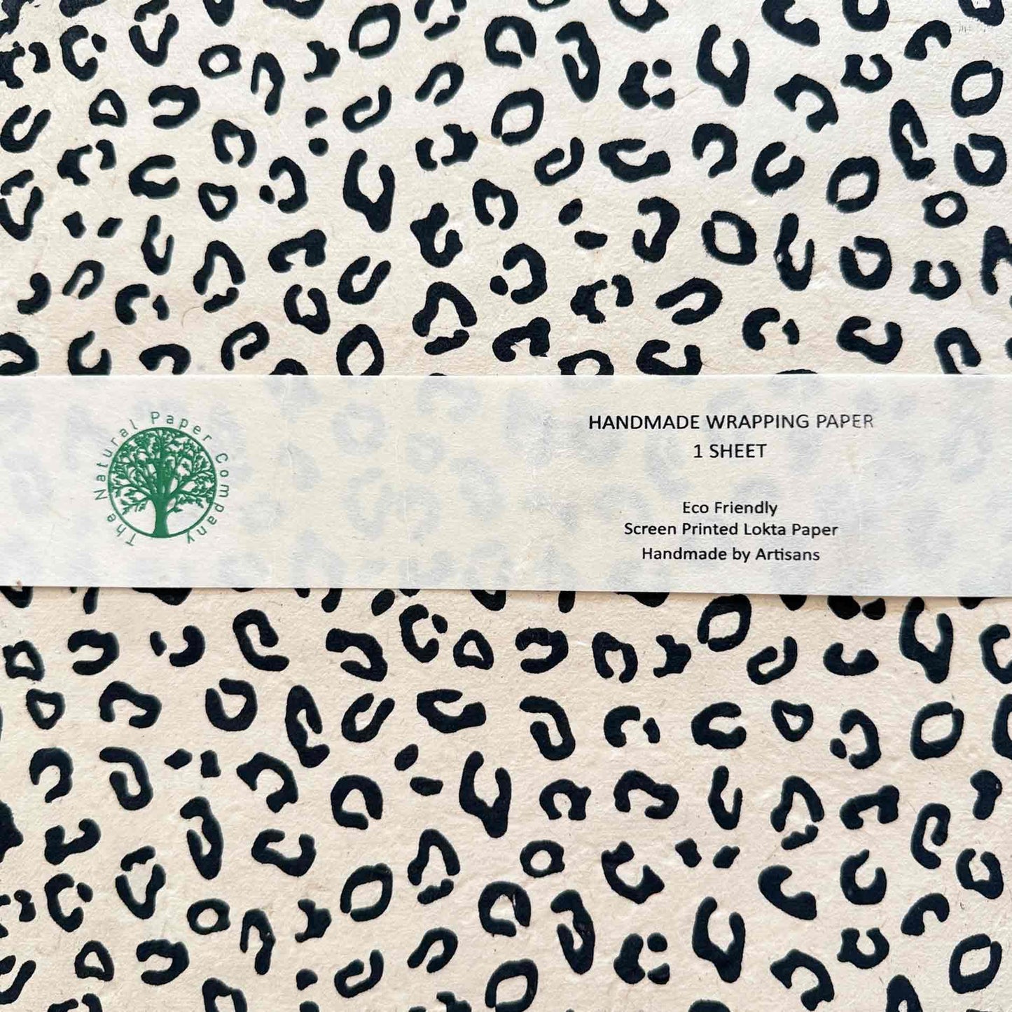 Close-up of leopard print Lokta wrapping paper sheet with product label – handmade eco-friendly gift wrap