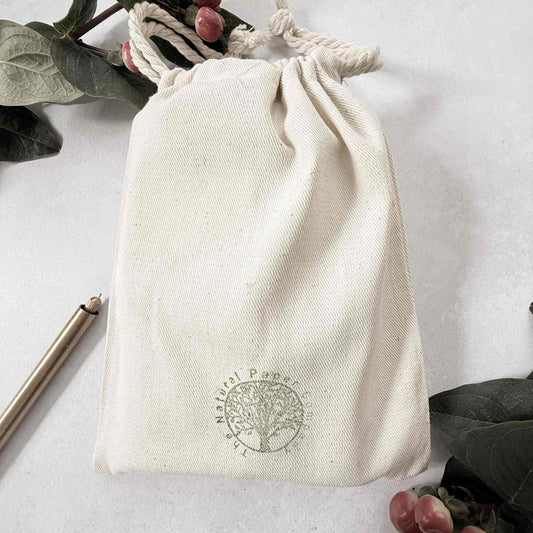 White drawstring bag with a logo on a light gray background