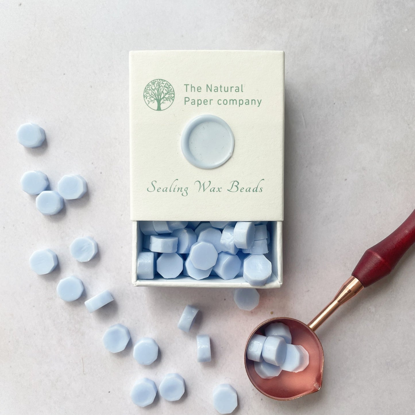 Box of sealing wax beads in sky blue. Light blue wax to make wax seals for invitations, envelopes and packaging. Plastic free, paraffin free and biodegradable wax. By The Natural paper Company